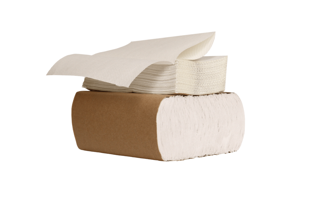 A bundle of white multifold paper towels sits on top of another bundle that is wrapped in natural paper