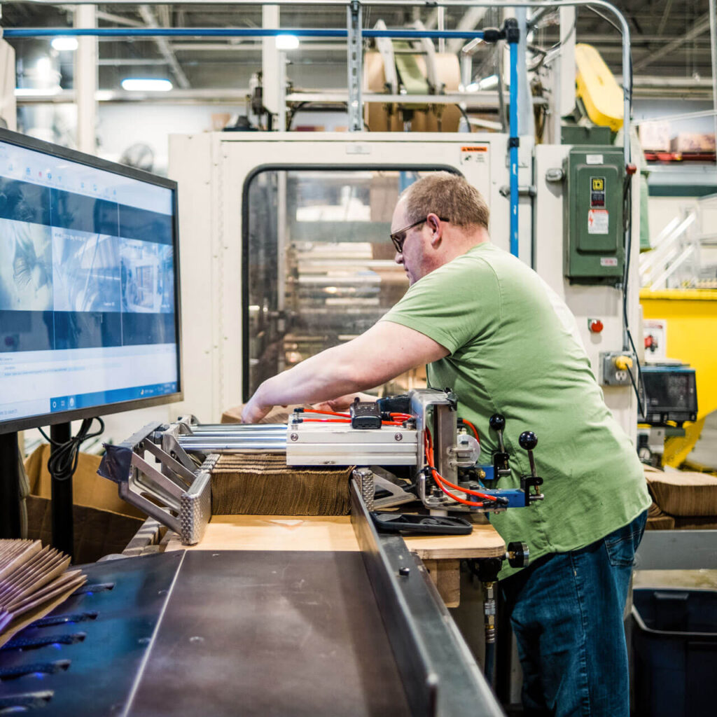 An Outlook Nebraska employee works with paper towels on the production line