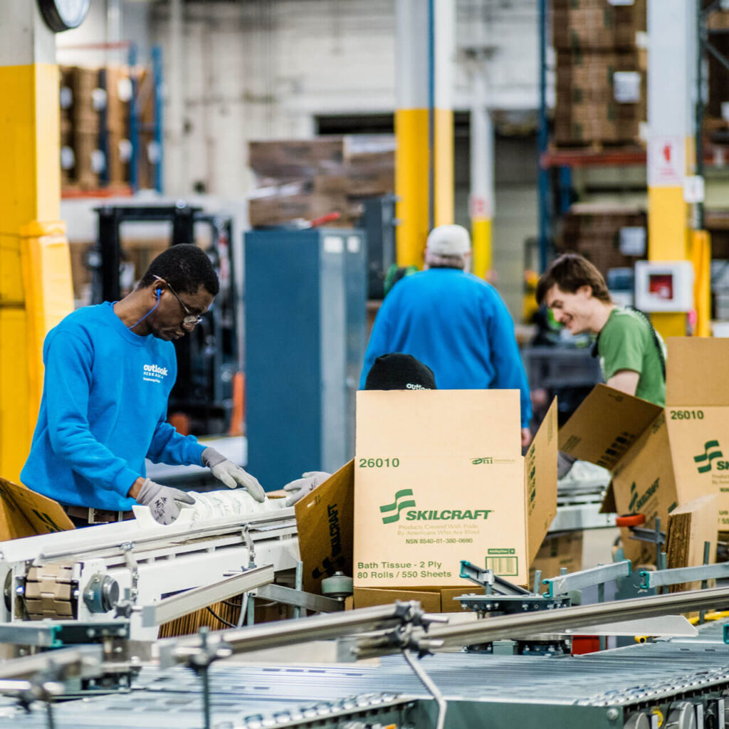 Three employees work on the production line