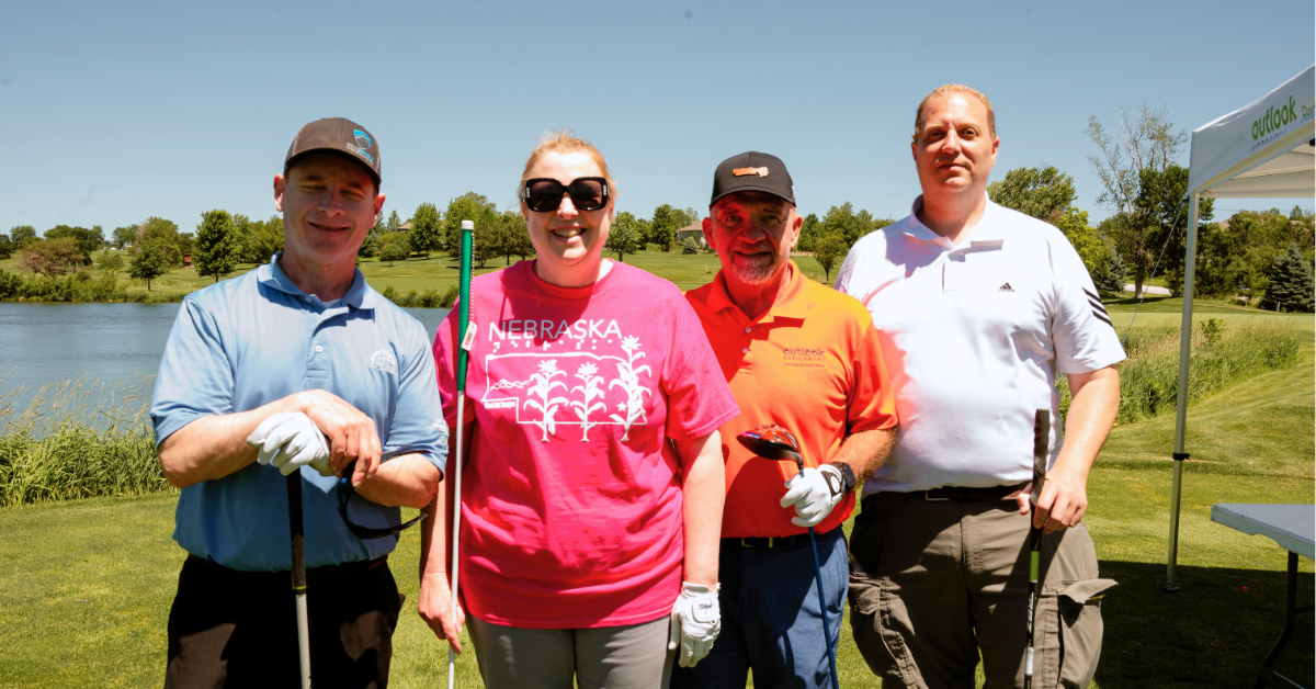 Photo of golfers smiling: Steve, Kristal, Glen and Rick.