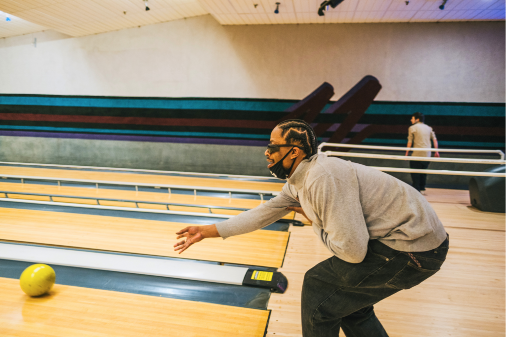 Mo throwing a bowling ball down the lane