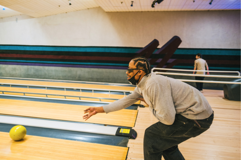 Mo throwing a bowling ball down the lane