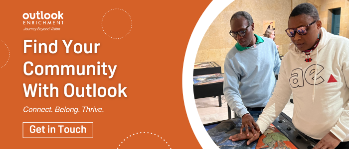 "Find Your Community With Outlook. Connect. Belong. Thrive. Get in Touch." Photo of a man guiding a woman at a tactile art event.