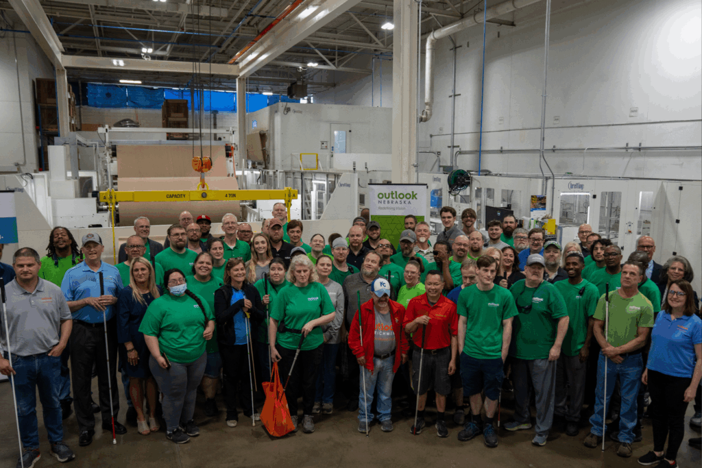 Group photo of Outlook associates on the manufacturing floor.
