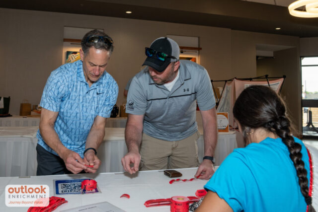 2 men purchasing raffle tickets.