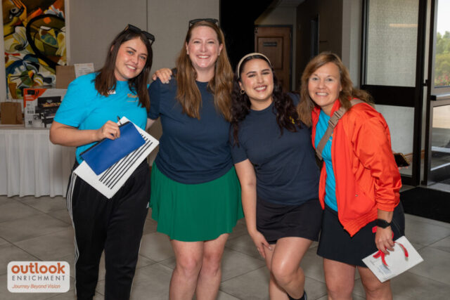 4 ladies smiling for a photo.
