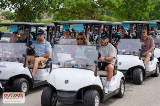 Golf carts with teams getting ready to head to the course.