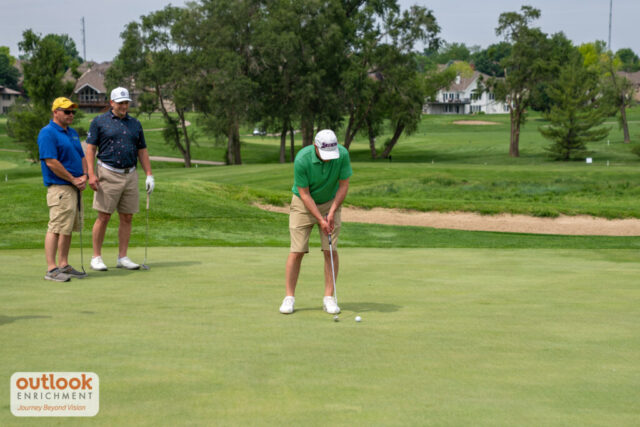A man putting on the green.