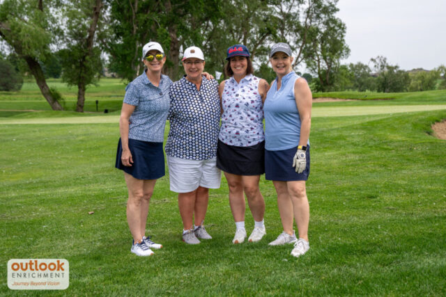 4 ladies smiling on the course.