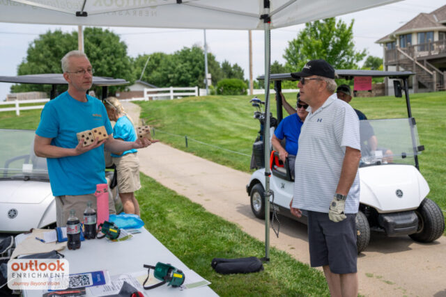 A male volunteer holding the dice.