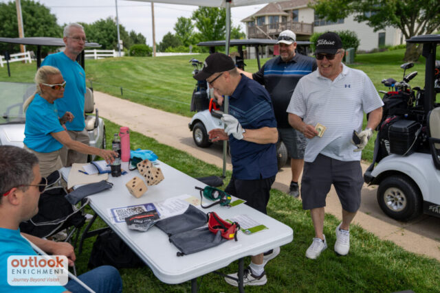A man rolling dice for a hole challenge.