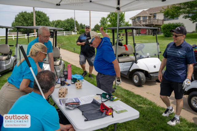 A man rolling dice for a hole challenge.