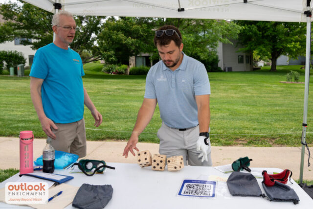 A man rolling dice for a hole game.