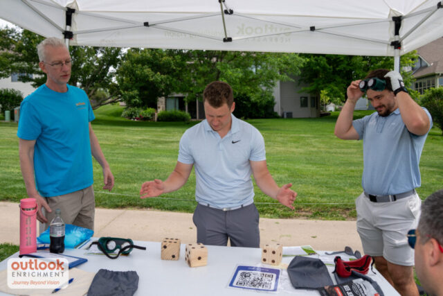 A man rolling dice for a hole challenge.