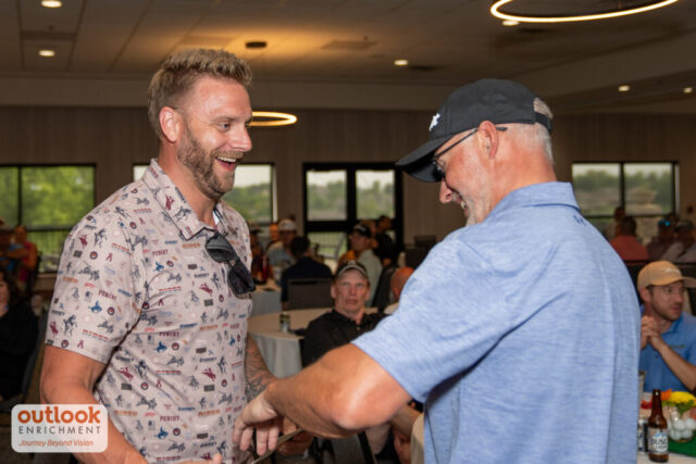 Two men talking/action shot at the banquet.