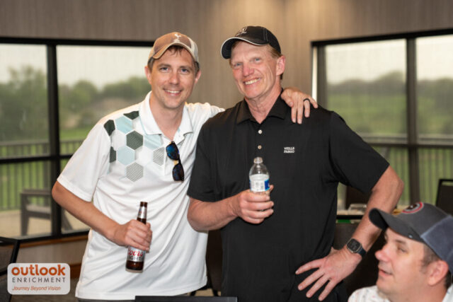 2 men smiling at the banquet portion of the night.