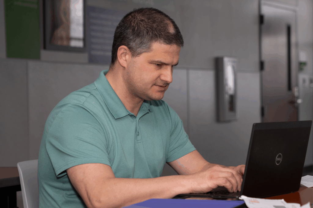 Photo of Outlook associate Ross using a laptop.