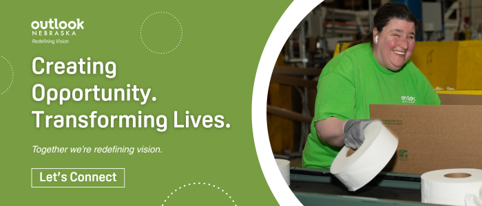 A female Outlook Nebraska associate is placing toilet paper into a box. Text: "Creating Opportunity. Transforming Lives. Together we're redefining vision. Let's connect."