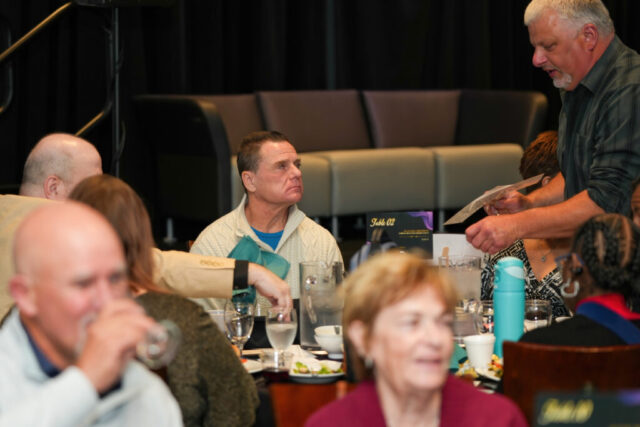 Kenny seated at a table.
