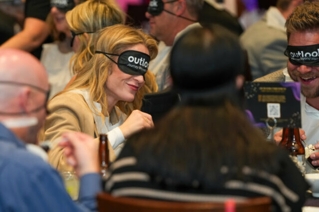 A table with their sleep shades on smiling.