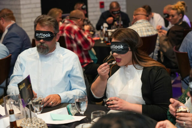 A man and women participating in Dessert in the Dark.