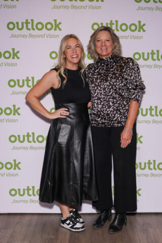 Cassie and Mary Fran in front of an Outlook backdrop.