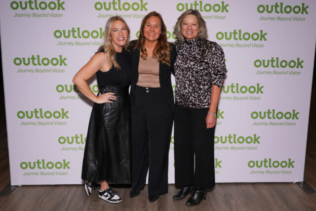 Cassie, Callie, and Mary Fran in front of an Outlook backdrop.