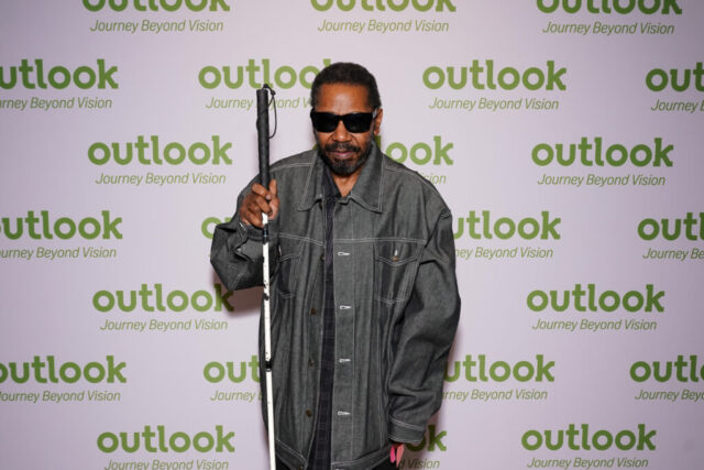 Alex in front of an Outlook backdrop.