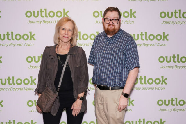 Nancy and Ben smiling in front of an Outlook backdrop.