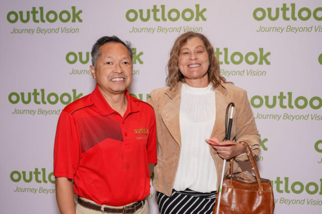 James and Megan are smiling in front of an Outlook backdrop.