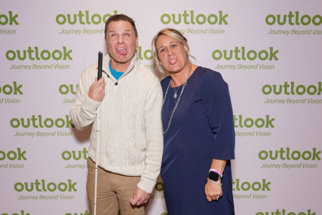 Kenny and Nina sticking our their tongues in front of an Outlook backdrop.