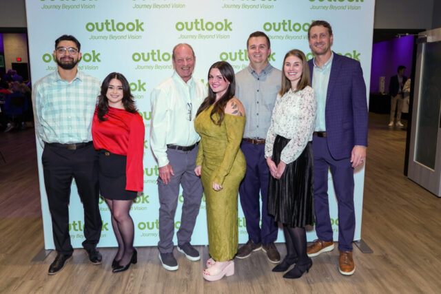 Montage Builders and guests are smiling in front of an Outlook backdrop.