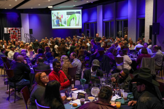 Overview of guests watching a video on the screen.