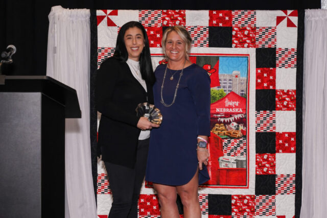 Nina smiling with Annie, Volunteer of the Year.