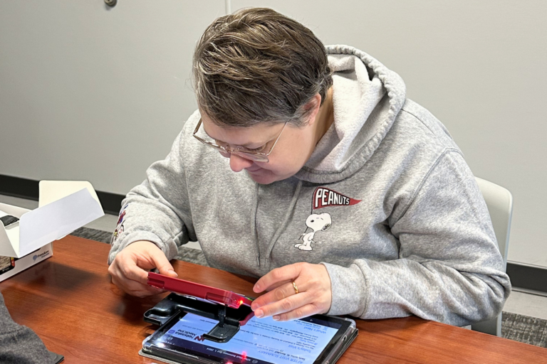 Sam is using an electronic magnifier.