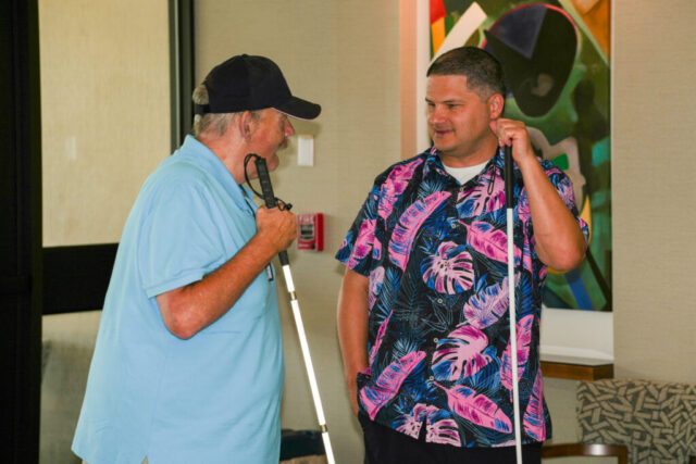 Ross and Tim talking by the building entrance.