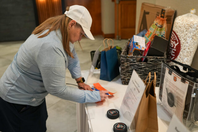 A woman is entering raffle tickets.