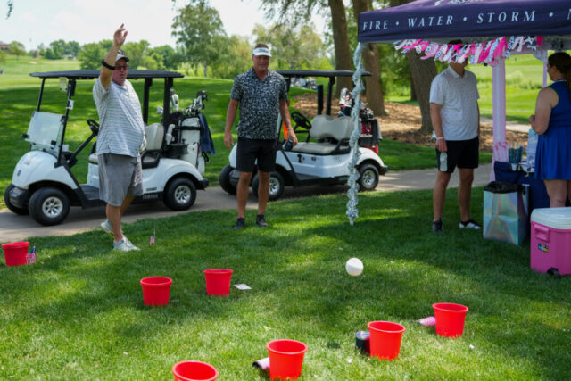 Wade and another man doing a bucket toss.