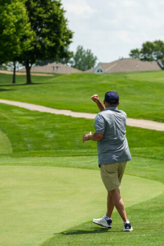 A man is doing a fist pump.
