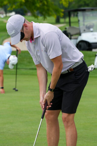 A man wearing sleepshades is putting.