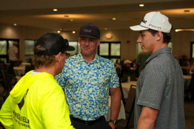 Steve is talking to two men.